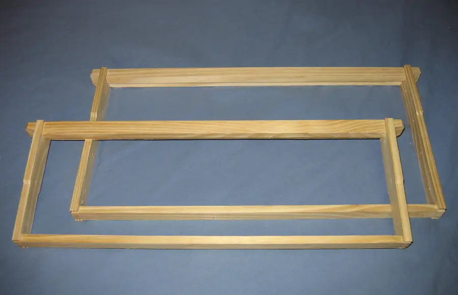 Two assembled wooden Langstroth frames with wedge top bars, a 9-1/8 inch deep and a 6-1/4 inch medium