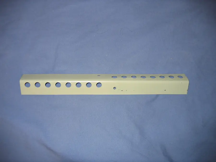 Metal mouse guard strip for a hive entrance, a green-gray angle with round holes in two sizes
