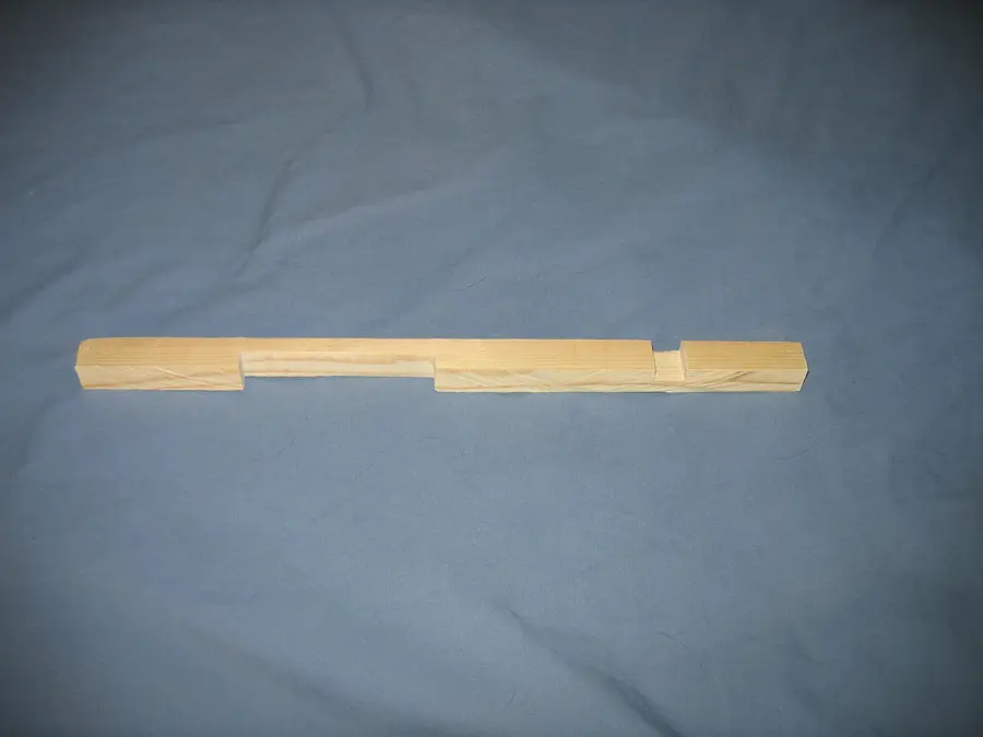 Wooden entrance reducer for a Langstroth hive, a pine cleat with a wide notch and a narrow notch