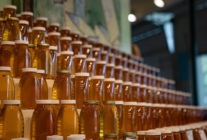 Photo of rows of bottled liquid honey in glass jars on tiered display shelves at the Minnesota State Fair