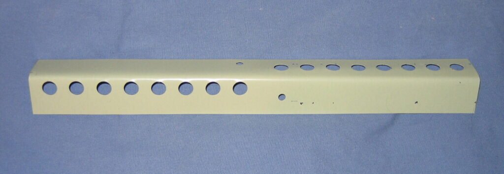Photo of a painted metal mouse guard strip with a row of round holes that let bees pass but keep mice out