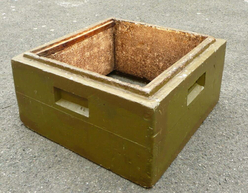 Photo of an empty polystyrene hive body with thick foam walls and a painted outer surface