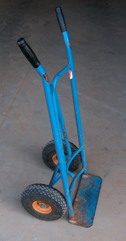 A standard two-wheeled hand truck, the same basic lever-and-wheel mechanism dedicated beehive-lifting hand trucks use to raise a loaded super