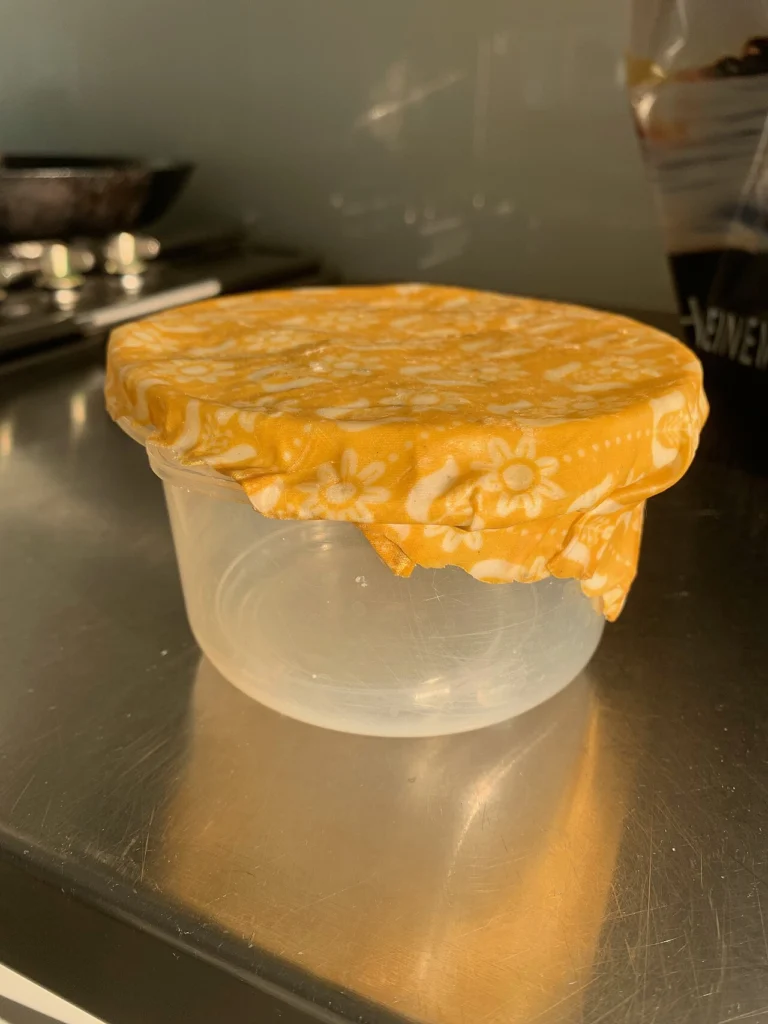 Finished beeswax food wrap molded over the top of a glass bowl