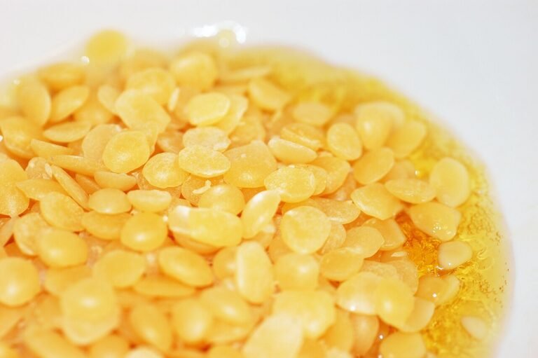 Beeswax pellets melting in a metal pan, the first step in making lip balm
