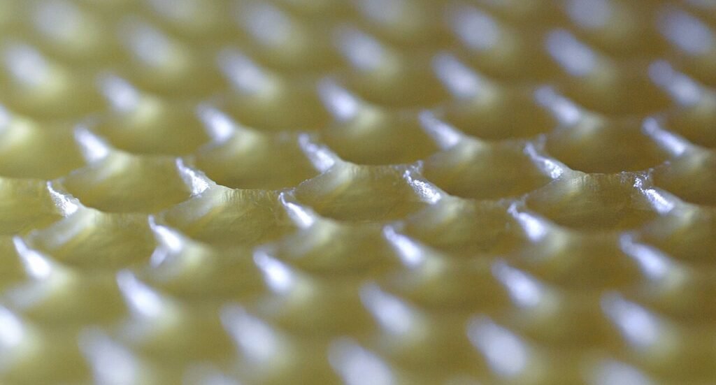Close-up photo of beeswax honeycomb foundation, useful as a hands-on classroom teaching sample
