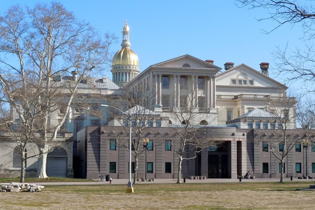 Exterior of the New Jersey State House with gold dome representing state beekeeping law authority in Trenton
