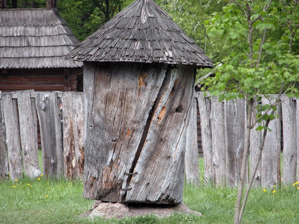 Traditional carved wooden log beehive on display at the Museum of Folk Architecture in Pyrohiv Ukraine