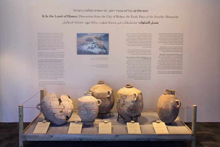 Museum exhibition panel titled It Is the Land of Honey displaying ancient storage jars and an aerial photo of the Tel Rehov excavation site in Israel