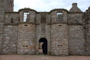 Photograph of the fortified stone entrance of Tolquhon Castle in Aberdeenshire, Scotland, showing its distinctive defensive firing slits