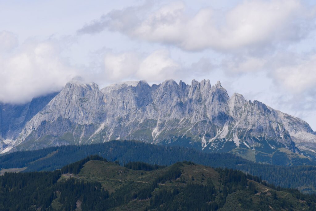 Alpine mountain range near St. Johann, Austria, the kind of high-elevation terrain where mountain beekeepers manage a compressed season