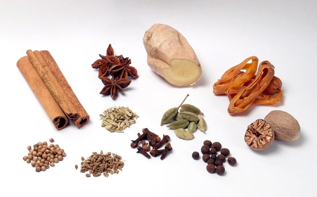 Assorted whole spices including cinnamon, cloves, ginger, and cardamom, common additions used to make a spiced metheglin mead