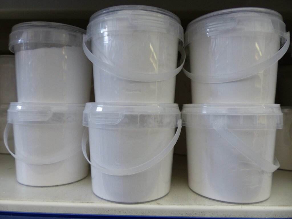 Close-up of baking soda powder, the alkaline leavening that offsets honey's natural acidity in a recipe