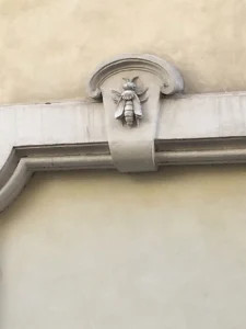 Carved stone Barberini bee emblem set into a Rome building facade