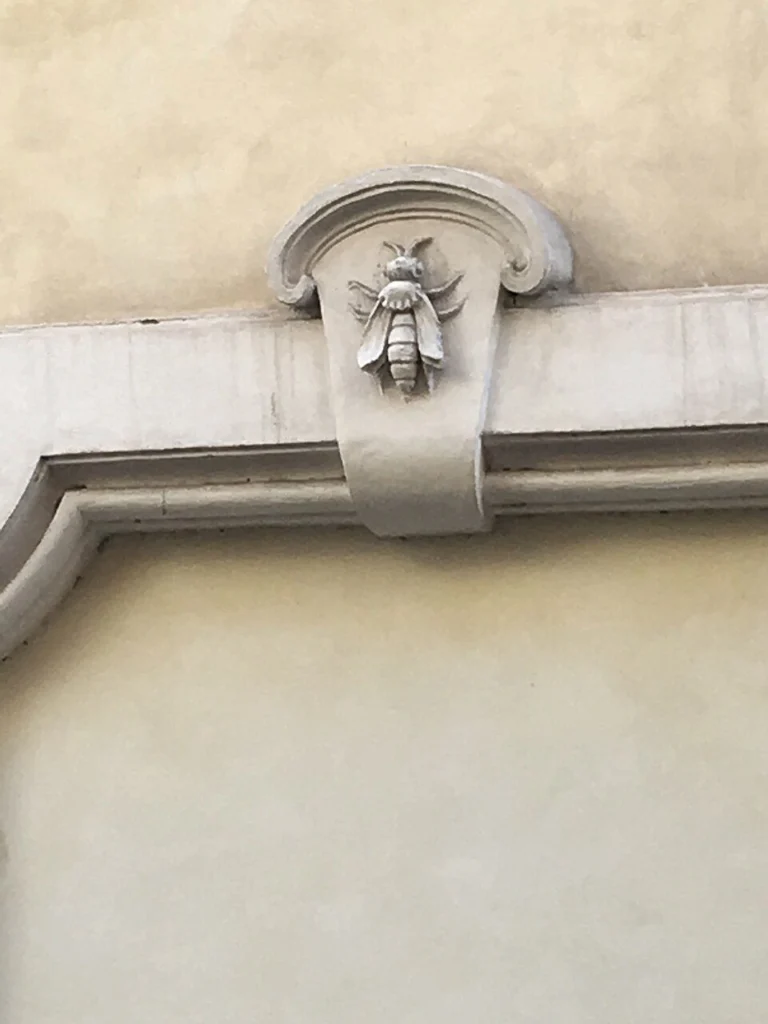 Carved stone Barberini bee emblem set into a Rome building facade