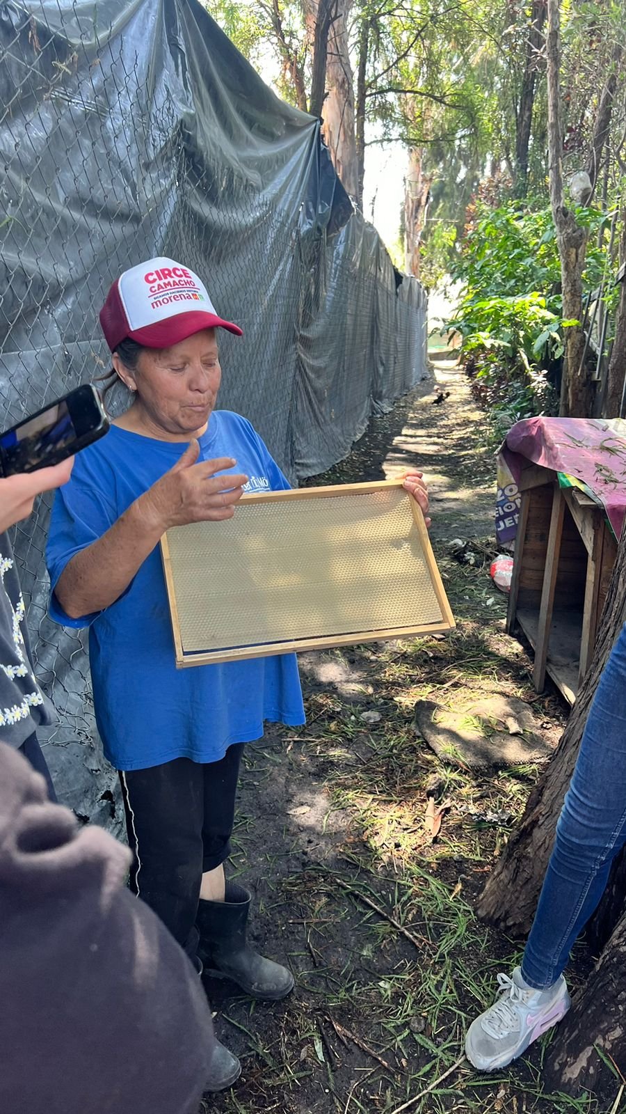 A beekeeping mentor teaching a group about the beekeeping process, the kind of education these scholarships support
