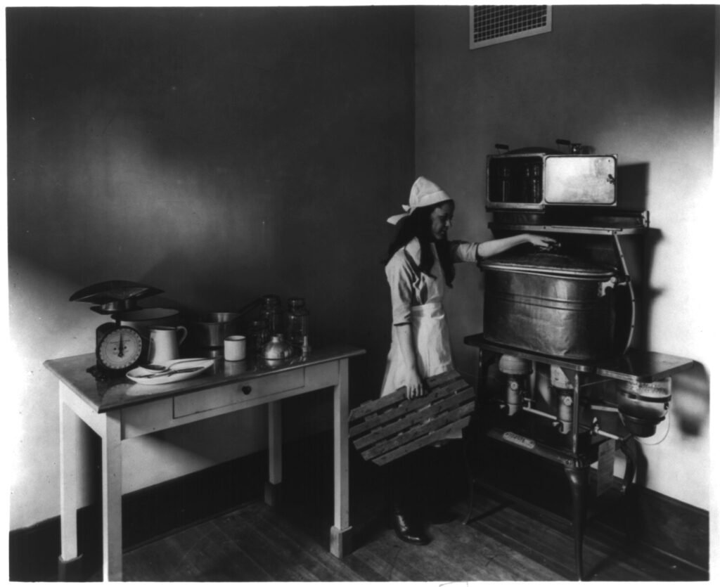 Vintage 1915 photograph demonstrating the cold-pack home canning method used before modern boiling-water canner guidance