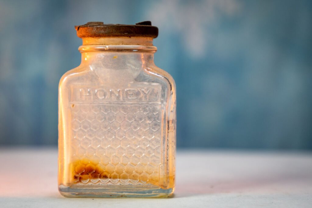 A jar of dark amber honey, the color and character typical of Jarrah honey