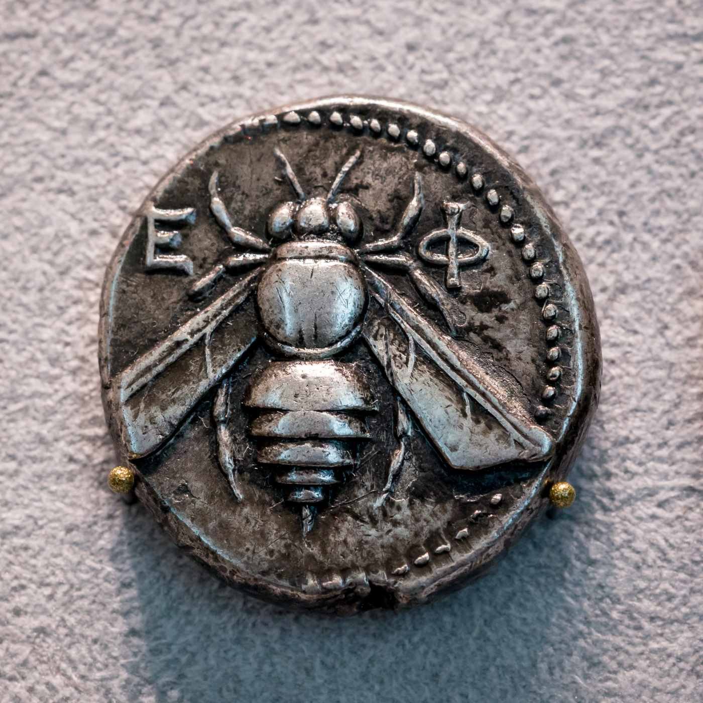 Ancient silver tetradrachm coin from Ephesus showing a bee with outstretched wings
