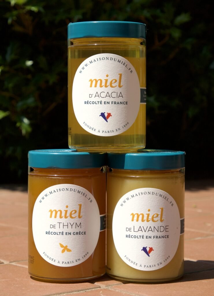 Three jars of light, mild-flavored monofloral honey, the type recommended for canning so flavor and color stay predictable