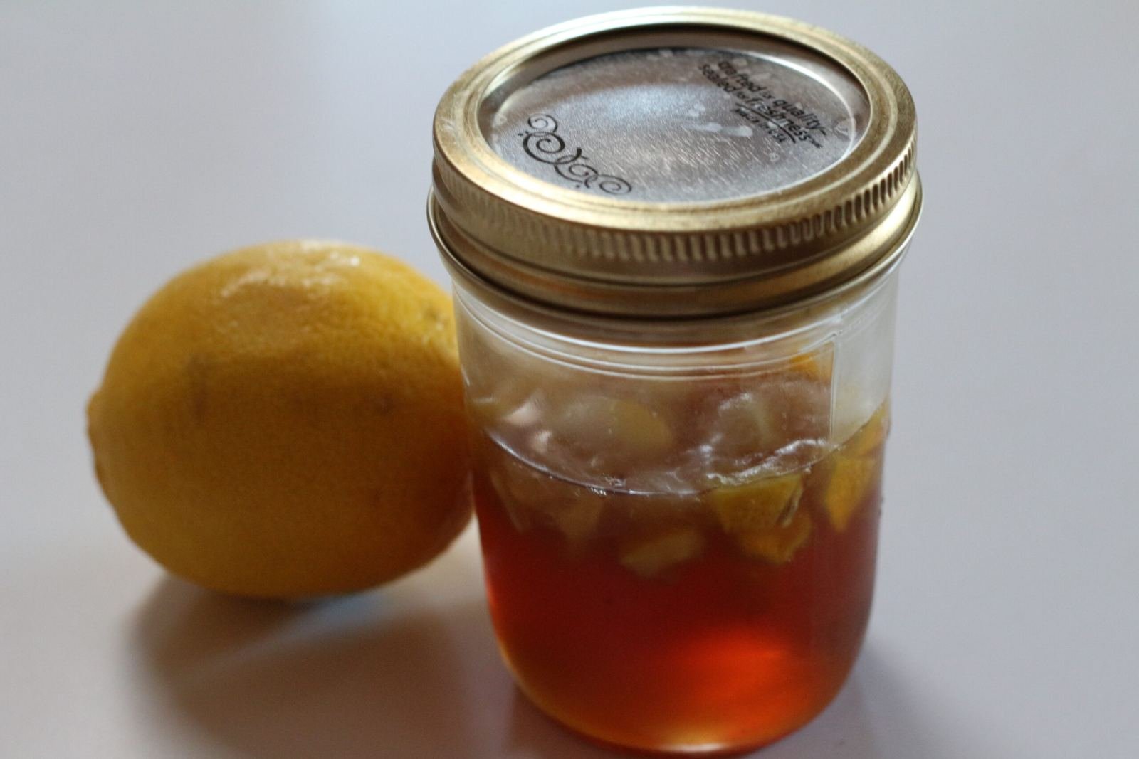 A fresh lemon and raw honey, the two base ingredients used to make honey syrup for cocktails