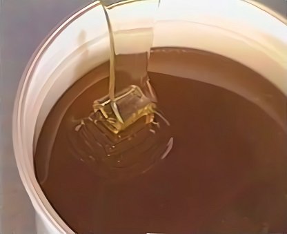 Freshly extracted honey being poured into jars during processing