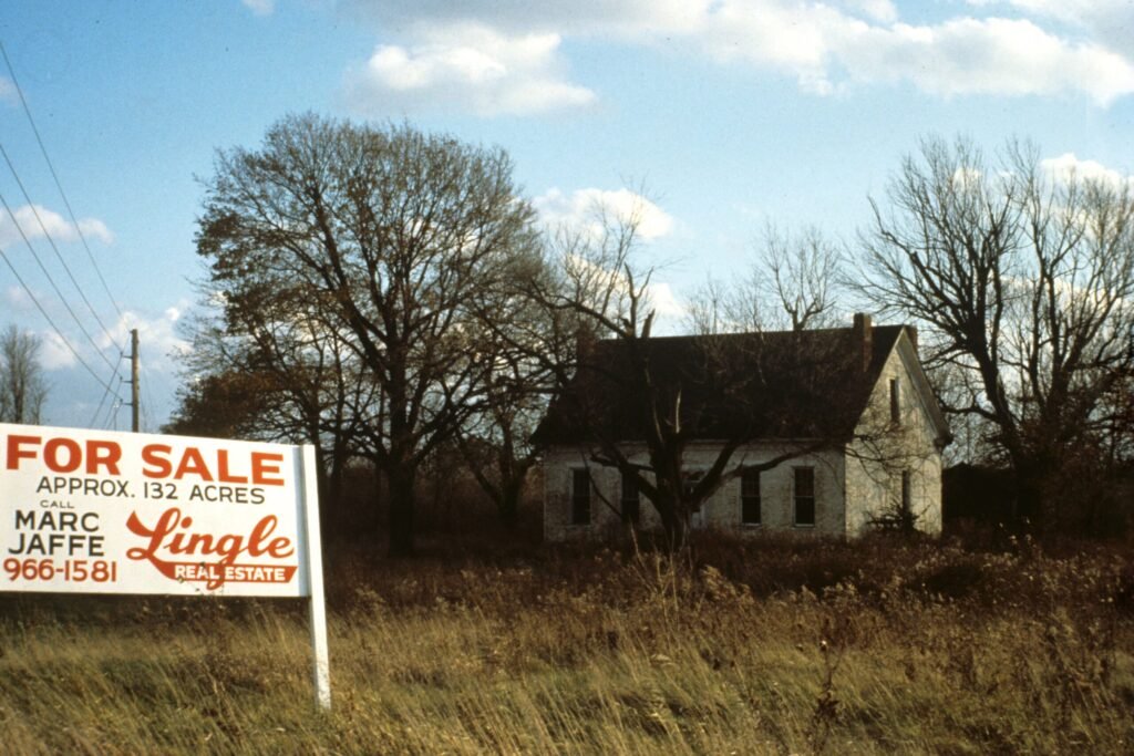A house with a for sale sign in the front yard, the kind of listing that may include a beehive as personal property