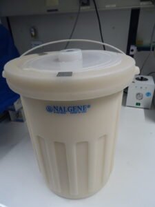 A laboratory Dewar flask used to store liquid nitrogen for genetic cryopreservation