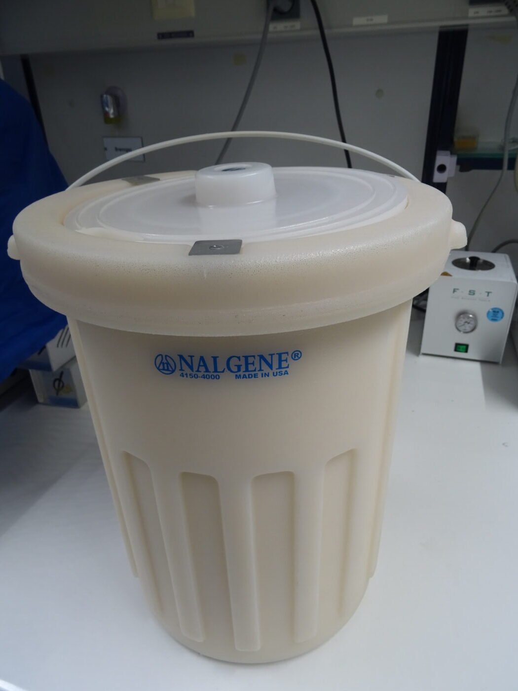 A laboratory Dewar flask used to store liquid nitrogen for genetic cryopreservation
