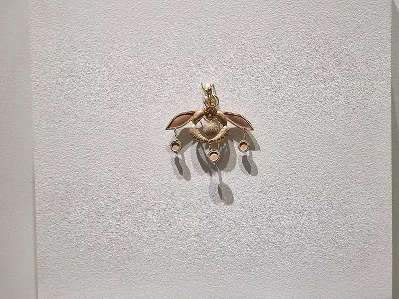 Close-up of the Malia Pendant's two gold insects with granulated central disc and dangling discs, Heraklion Museum