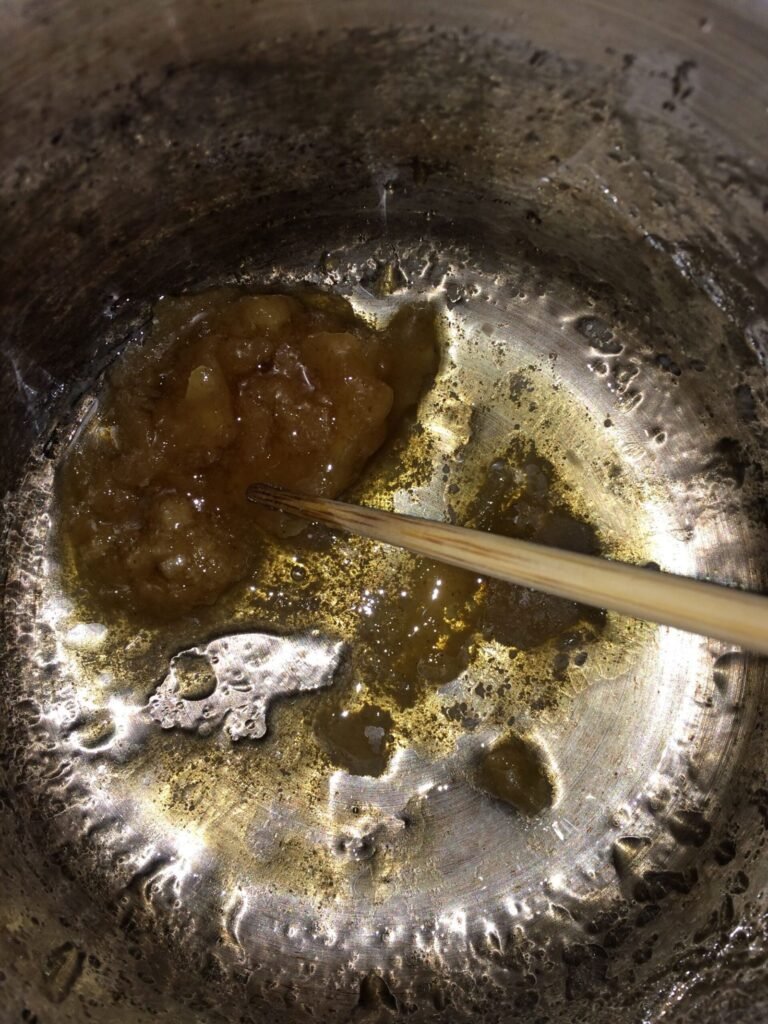 Raw beeswax being melted down for a craft project