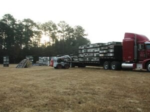 Flatbed semi-trailer loaded with stacked beehive pallets for migratory pollination transport
