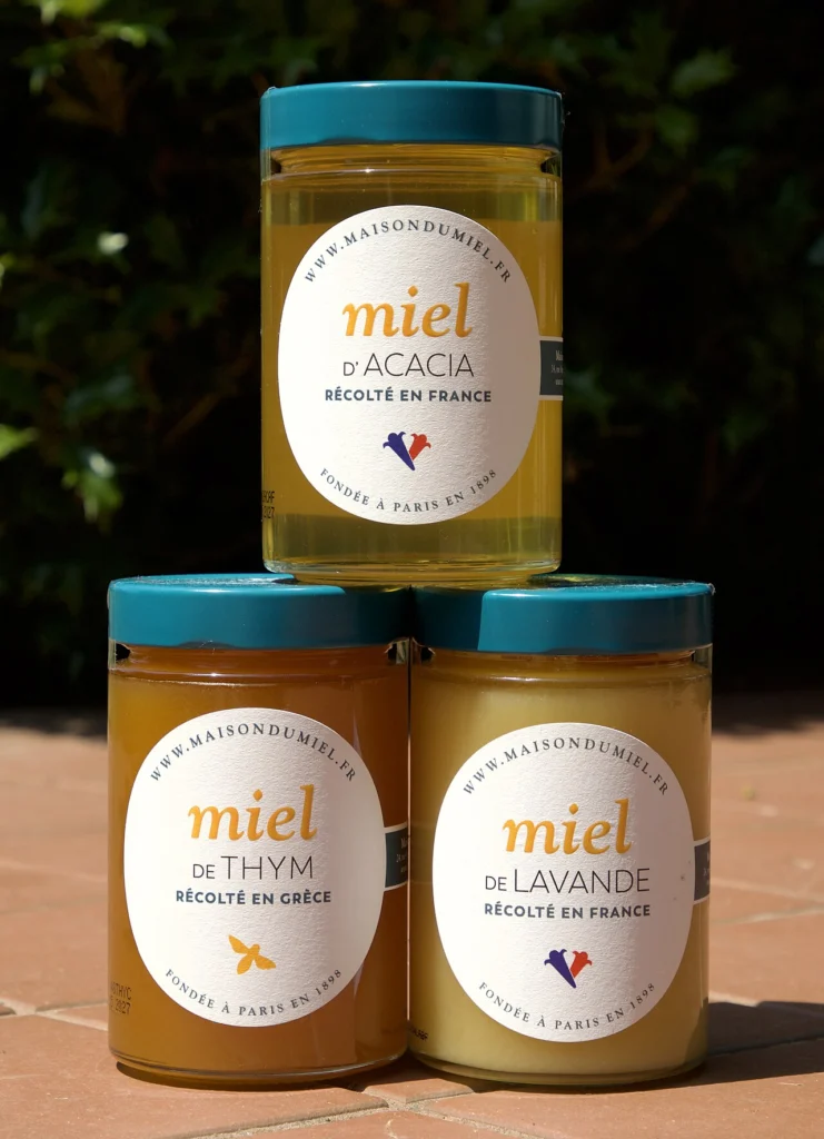 Three different jars of monofloral honey side by side, illustrating the varietal variety typical of a curated honey subscription box