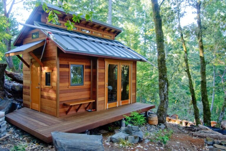 Small wooden cabin tucked among trees, the kind of vacation or second-home property some owners keep bees at