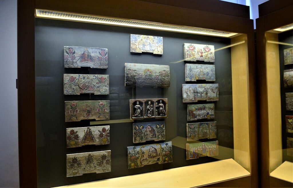 Decorative painted historical beehive front panels displayed at the Apiculture Museum in Radovljica, Slovenia