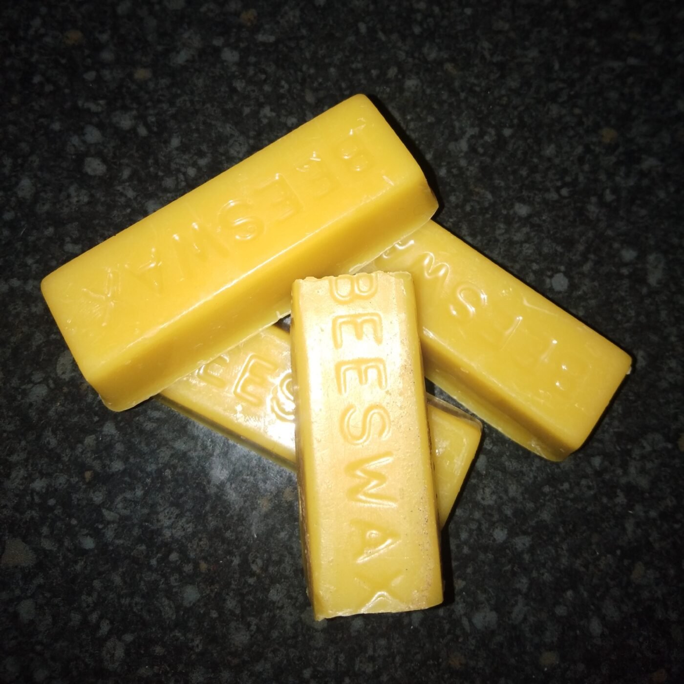 Four blocks of pure natural beeswax stamped with the word beeswax