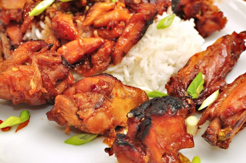Honey glazed chicken wings with a sticky caramelized coating on a serving plate