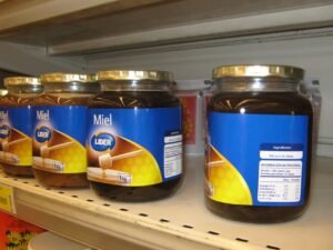 Jar of raw honey illustrating glass as a sustainable, low-waste packaging material