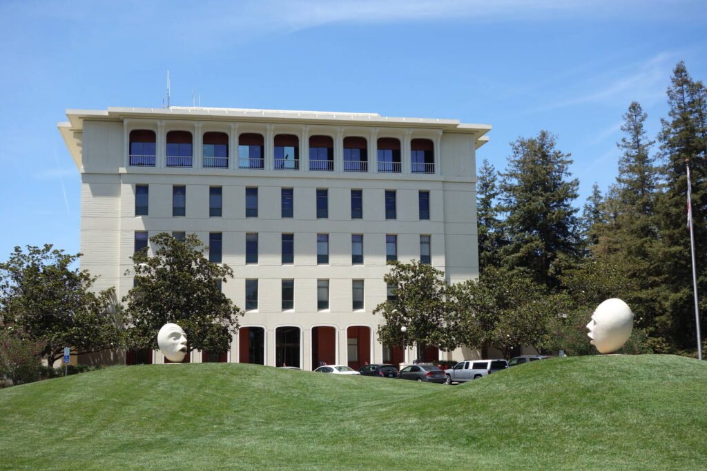 A University of California, Davis campus building framed by lawn and trees