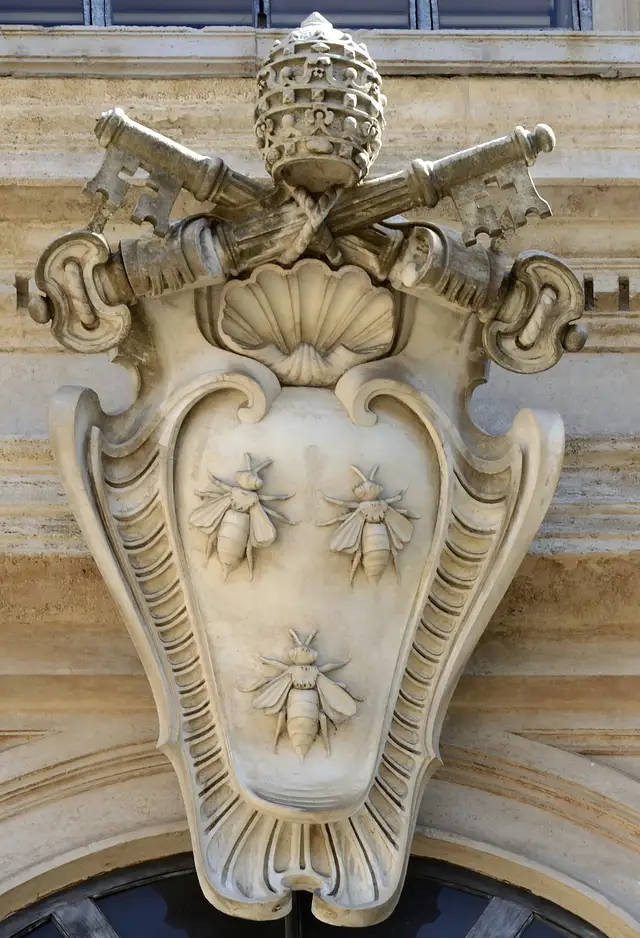Carved stone Barberini coat of arms with three bees on a shield beneath crossed keys and a papal tiara