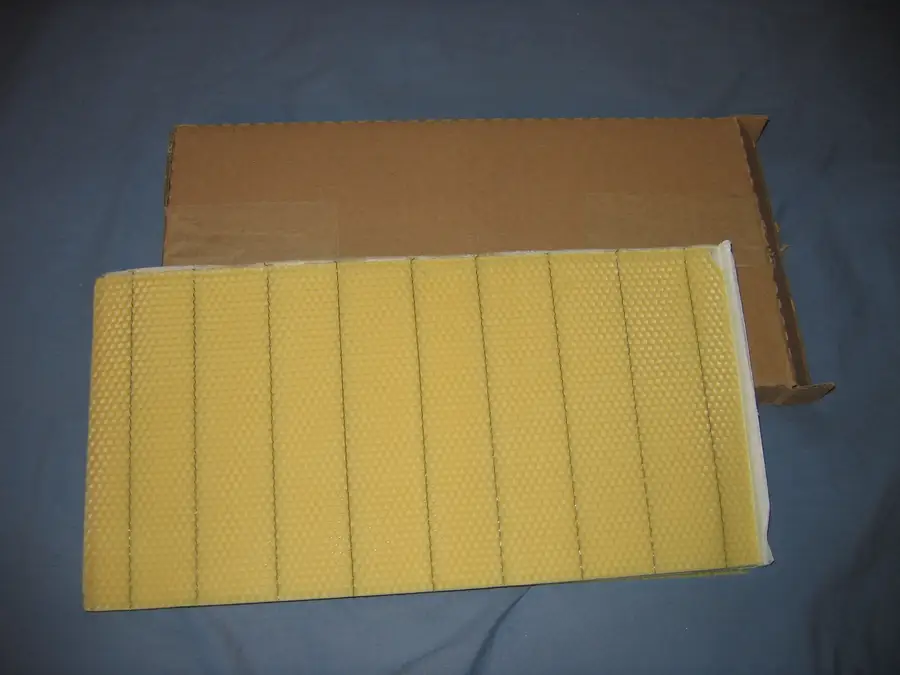 Sheets of crimp-wired beeswax foundation in a cardboard box, ready to fit into wedge-top Langstroth frames