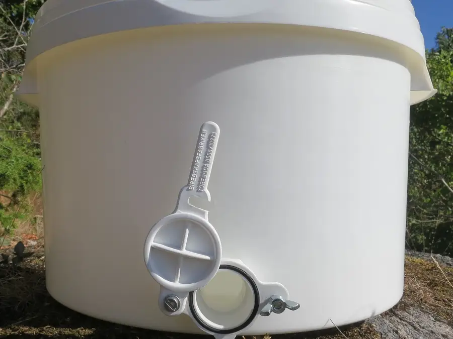 White food-grade plastic honey bucket with a snap-on lid and a plastic honey gate valve near the base